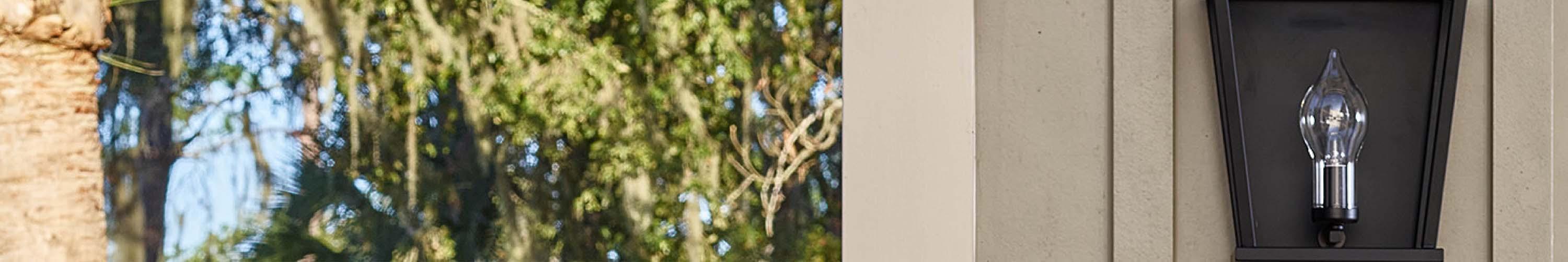 black outdoor sconce on a tan exterior wall